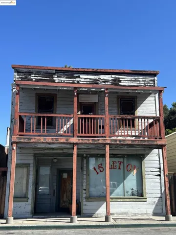 Back of house featuring a balcony