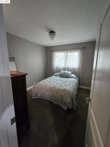 Bedroom featuring carpet floors and a textured ceiling