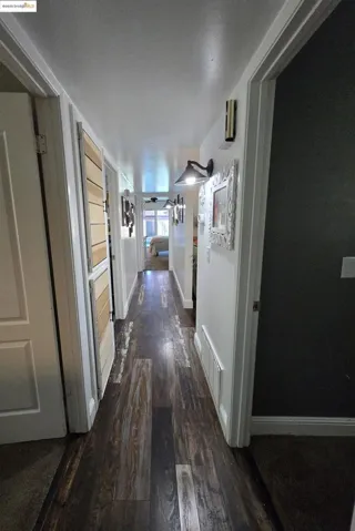 Hall featuring dark wood-style floors