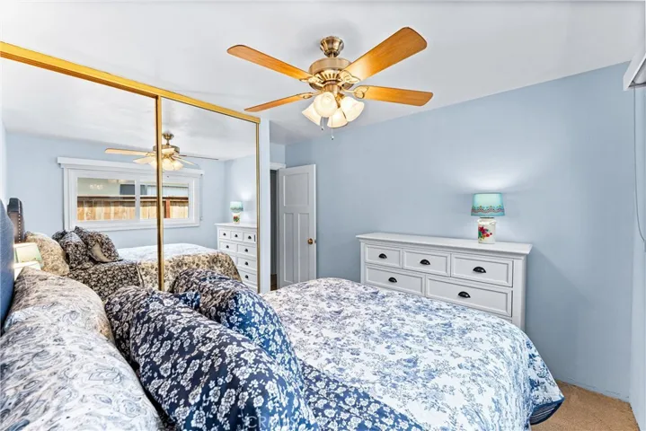 Bedroom 3 with ceiling fan and mirrored wardrobe closet doors