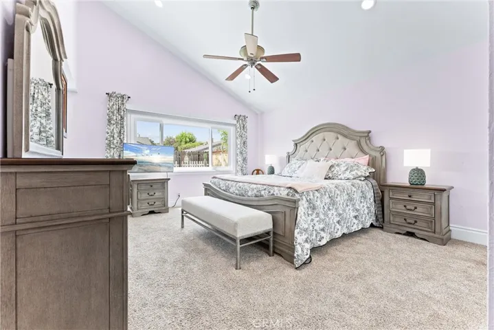 Spacious Primary Bedroom with ceiling fan and vaulted ceiling