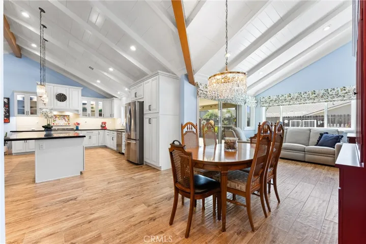 Tile floors that look like wood, vaulted ceilings with can lights, island and dining room
