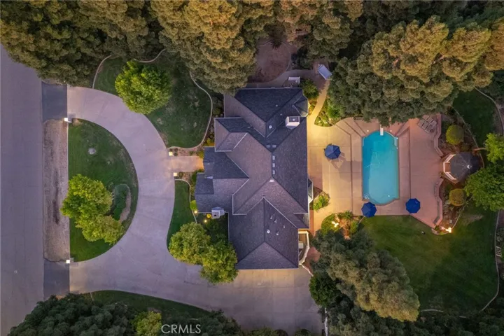 Overview of home, approach, and circular driveway along with pool area