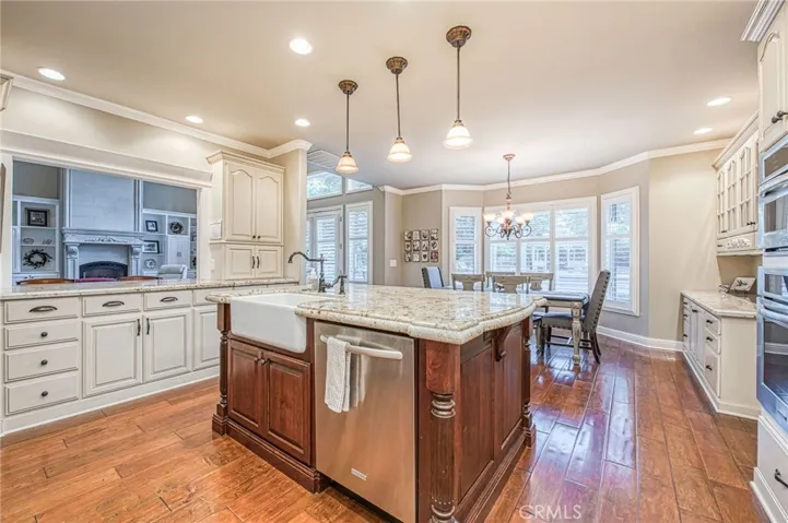 Kitchen island with view of custom breakfast bar with storage