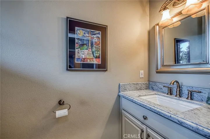 Powder room in laundry area with direct access from pool area and garage