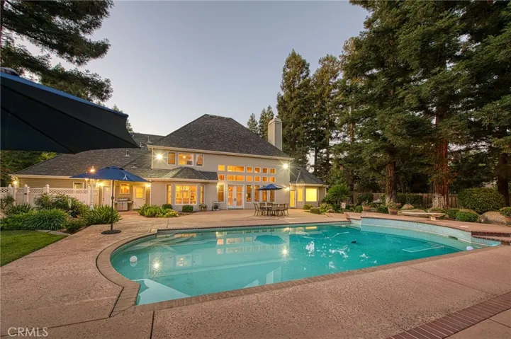 Back yard pool area and home at dusk