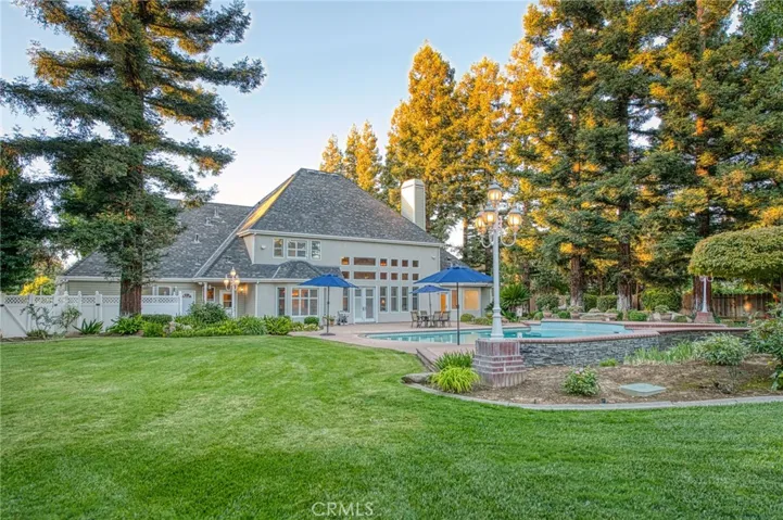 backyard view of home and pool area from garden area
