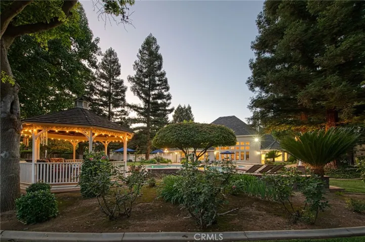 View of the backyard, from the back fence, displaying the gazebo and back of home