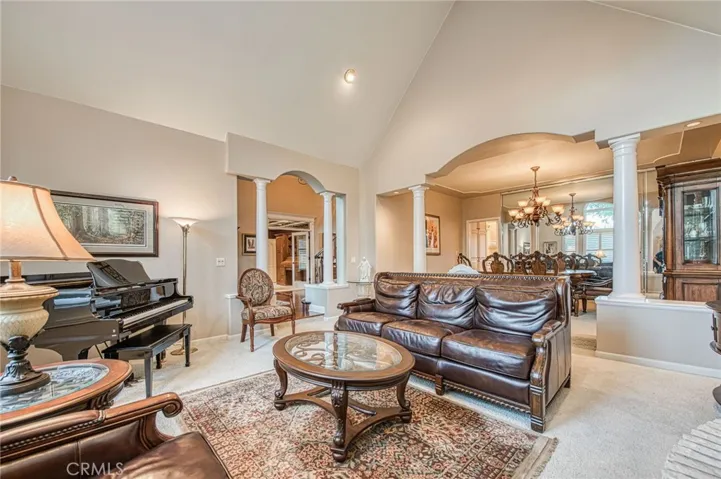 Formal living room showing entryway to foyer, and formal dining room