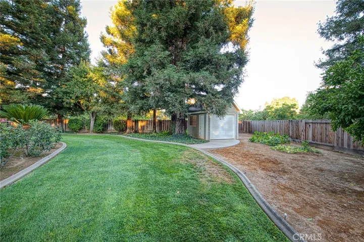 Facing southeast corner of backyard and shed/shop from gazebo area