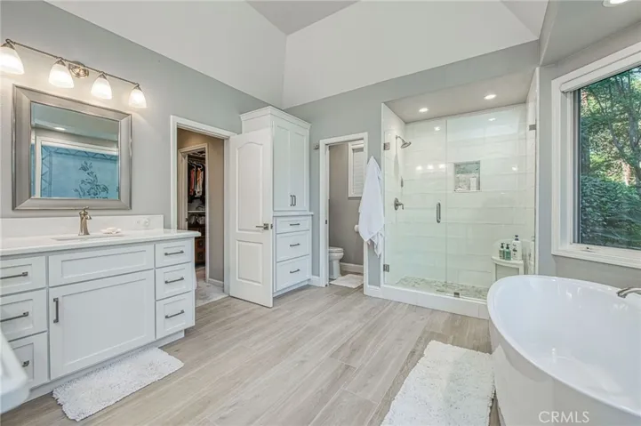 Primary en-suite bathroom displaying walk-in shower and entry from primary suite