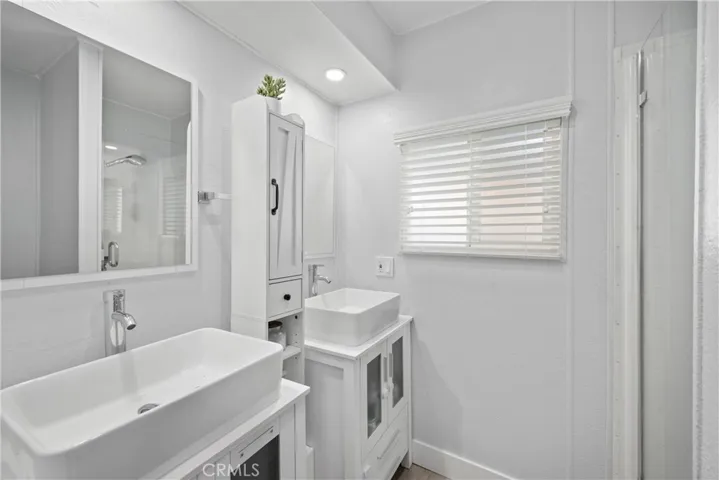 Primary private bathroom with standup shower and dual sinks