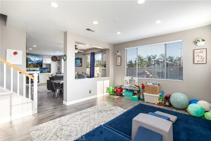 Spacious living room is currently being used as a playroom.