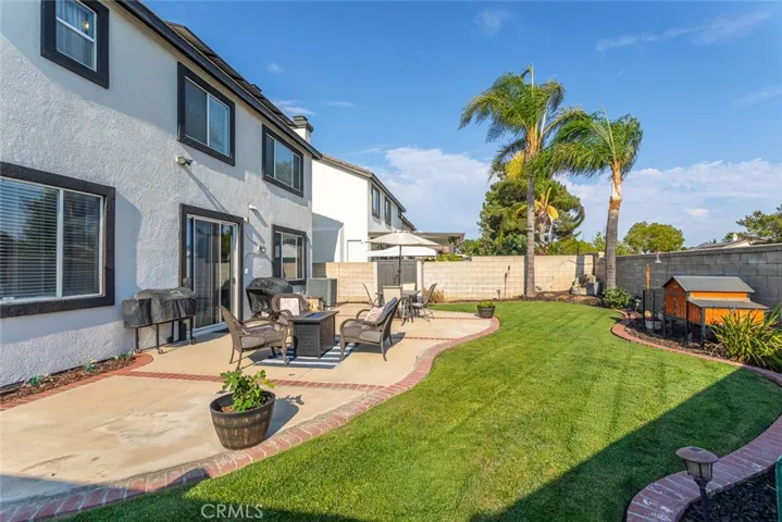 Professionally landscaped backyard with fresh mulch and lush green lawn.