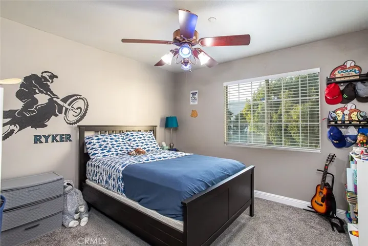 Bedroom with newer carpet, wide baseboards and energy-saving ceiling​​‌​​​​‌​​‌‌​​‌​​​‌‌​​​‌​​‌‌​​‌‌​​‌‌​​​​ fan.