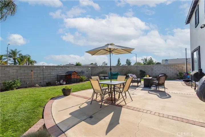 Professionally landscaped backyard with block wall, fresh mulch, and drought-tolerant plants.