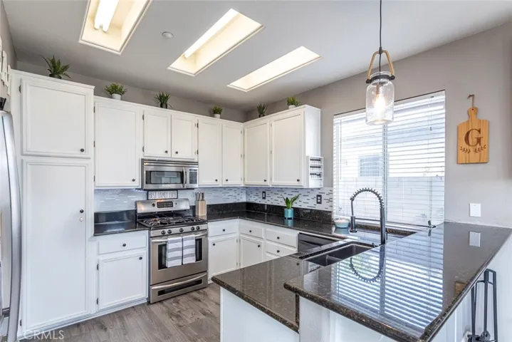 Desirable kitchen with newer tile backsplash, granite counters, and stainless appliances.