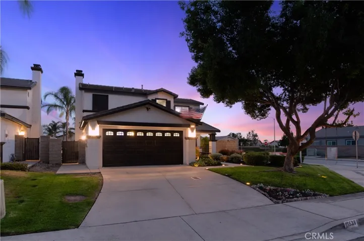 Attractive corner lot with fresh exterior paint, lush green lawn, and drought-tolerant plants.