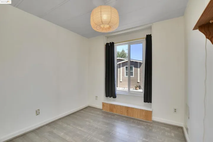 Empty room with wood finished floors and baseboards