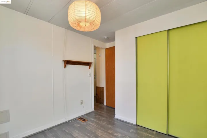 Unfurnished bedroom with dark wood finished floors and a closet