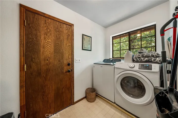 Lower laundry center with storage. Leads to attached finished garage