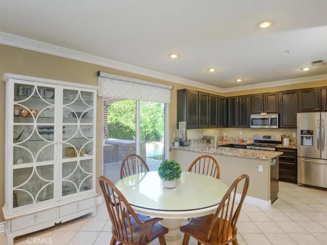 Dining area and kitchen with designer shade on slider to back yard