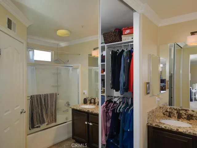 Peek a boo view into walk in closet with mirrored closet doors