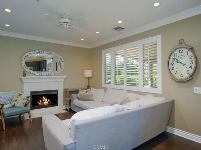 Family room with fireplace, crown molding, plantation shutters and recessed lighting