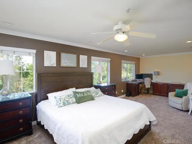 Primary bedroom with adjoining sitting area, home office or potentially an additional bedroom. Also, has spectacular views to golf course