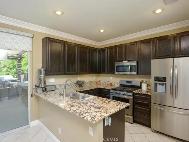 Stunning galley kitchen with granite counters, breakfast bar and stainless steel appliances