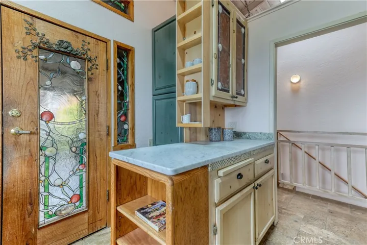 Stained glass door leads to the front patio