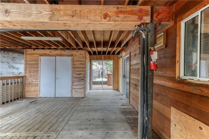 Bedroom 3 sliding glass doors lead to this covered deck with storage