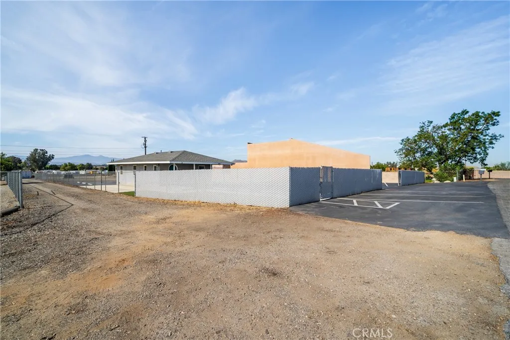 fenced driveway to enter around office into property