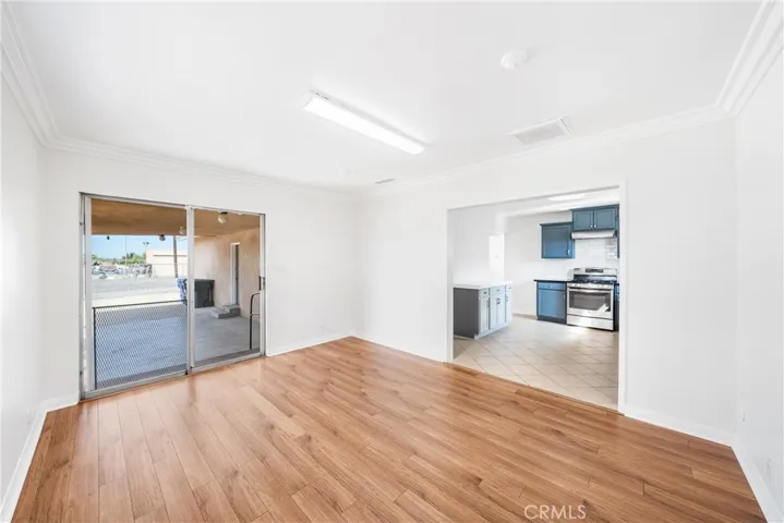 darling dining room opening to your kitchen and back patio! upgraded wood laminate flooring!