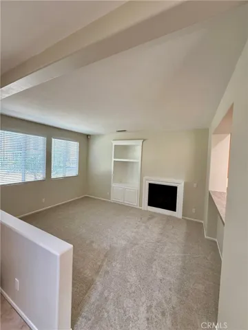 Formal living room opens to the kitchen.