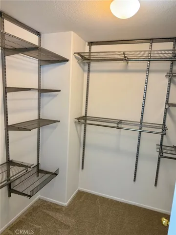 Owner's suite closet has custom storage.