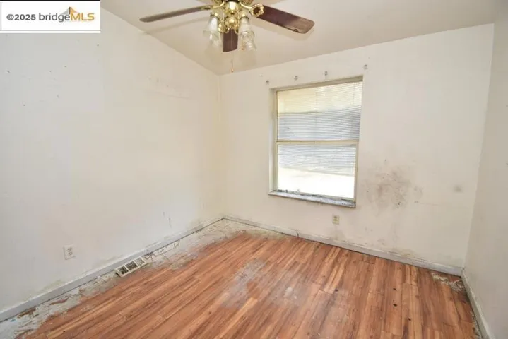 Empty room featuring wood finished floors and ceiling fan