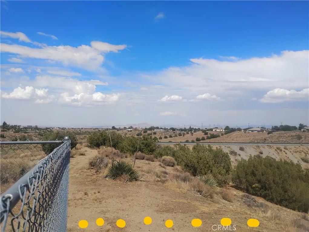 This is a view from the far right corner of the abutting property fence line overlooking the property for sale as the land gently slopes.