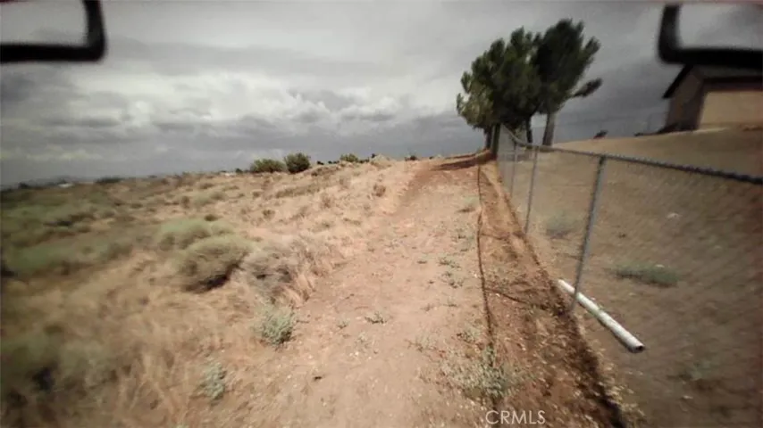 The property sits to the left of the fence line at the rear of the abutting property.