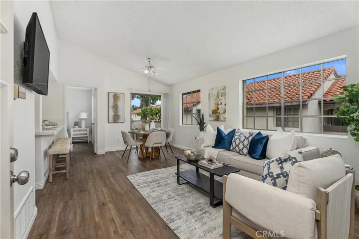 Open floor plan features vaulted ceilings and LVP flooring