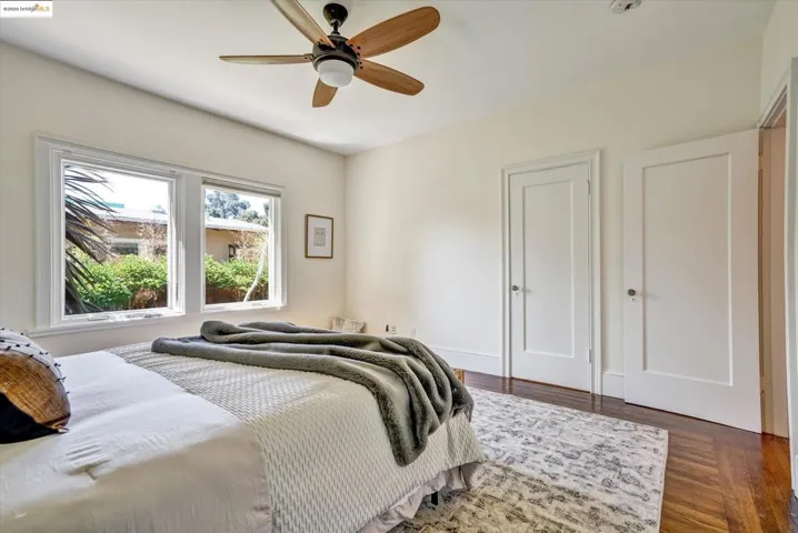 Bedroom with dark wood finished floors and ceiling fan