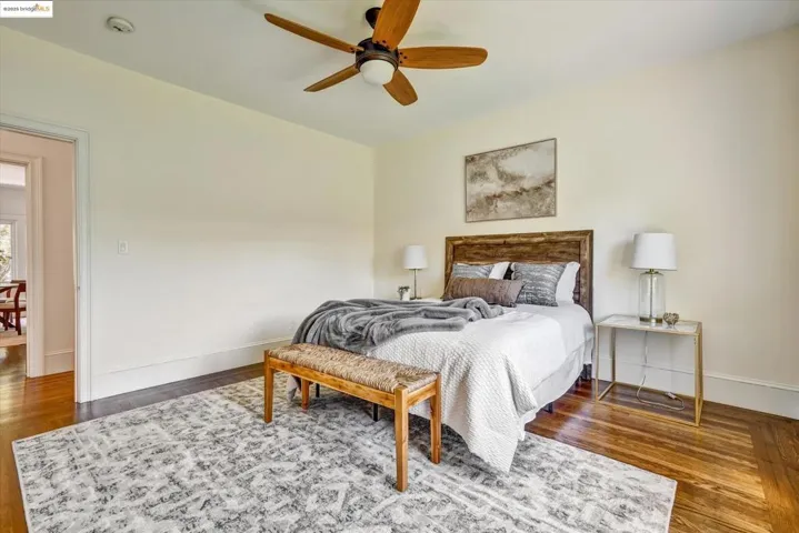 Bedroom featuring dark wood-type flooring and a ceiling fan