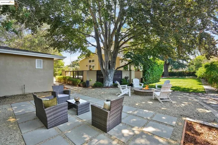 View of patio featuring an outdoor living space with a fire pit