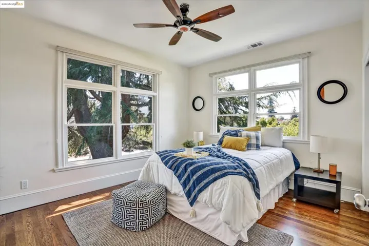 Bedroom with wood finished floors and ceiling fan
