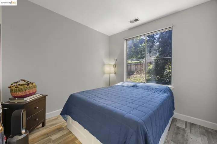 Bedroom with light wood-type flooring and baseboards