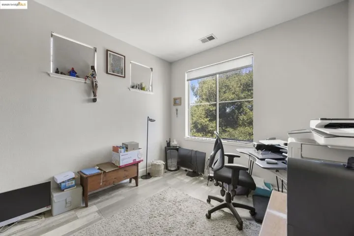 Office area with light wood-style floors and baseboards