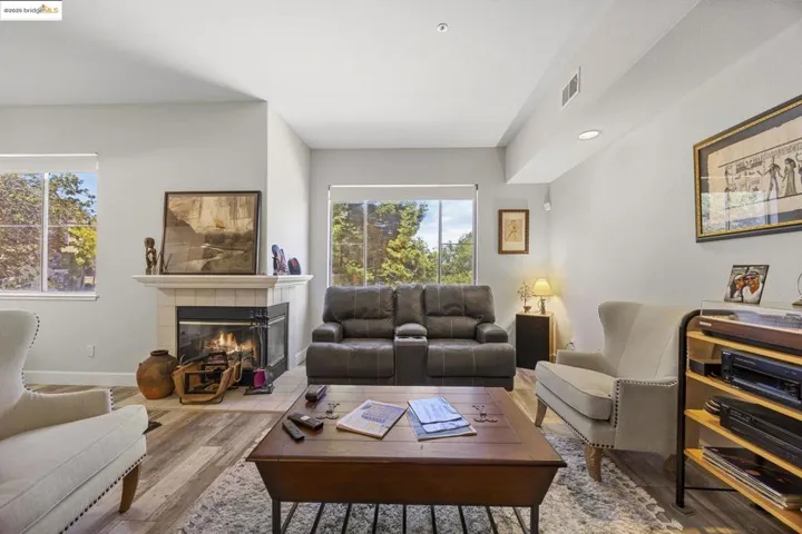 Living area featuring wood finished floors, a fireplace, and recessed lighting
