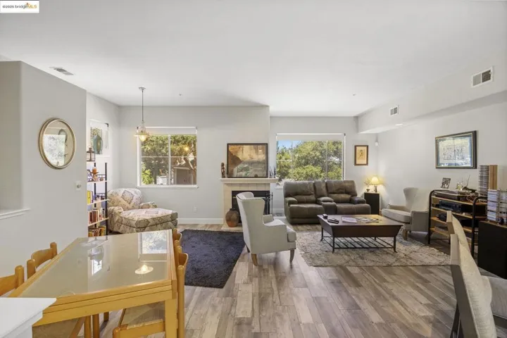 Living area with wood finished floors and a tiled fireplace