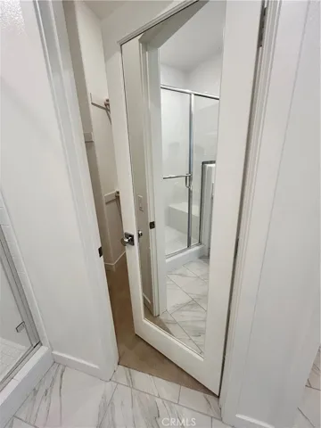 Primary closet with full glass mirror