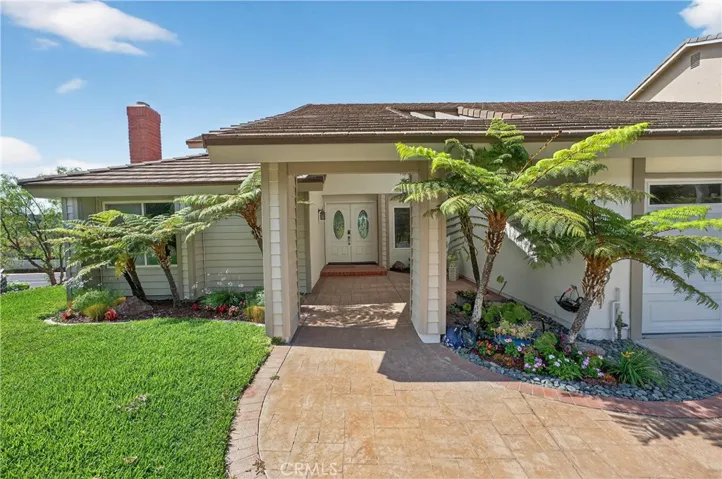 Beautifully maintained yard with covered entry